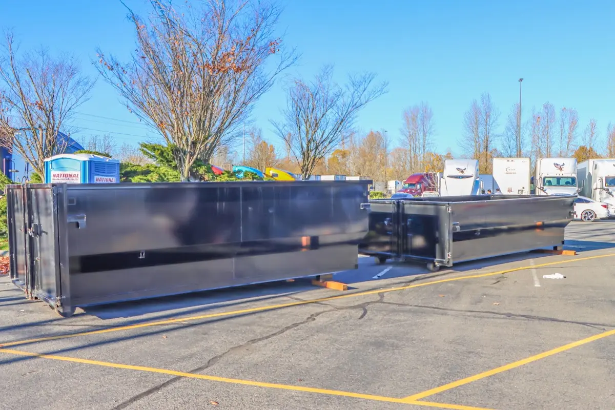 Professional dumpster rental service with roll-off container on residential driveway in Sanford